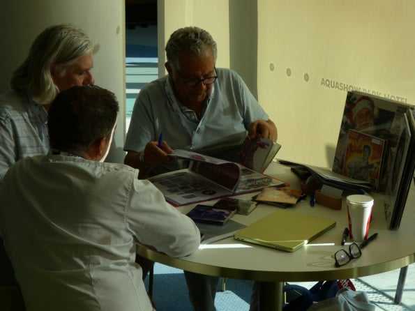 Two attendees looking through catalogues